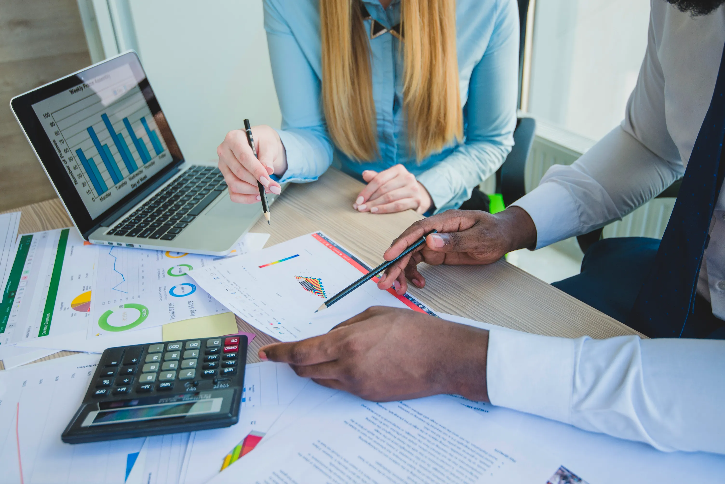 Corporate finance team reviewing business records